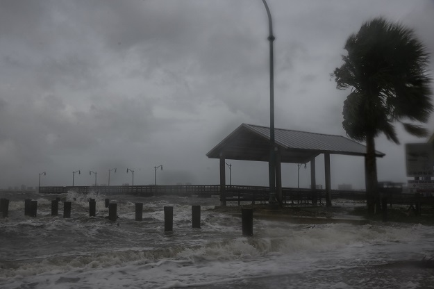 Strong gusts of wind and bands of heavy rain cover a pier at the Jensen Beach Causeway Park in Jensen Beach, Florida. PHOTO: AFP