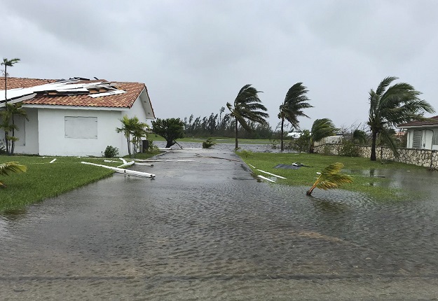 Debris is scattered on a flooded road near houses in Freeport in the Grand Bahamas. PHOTO: AFP