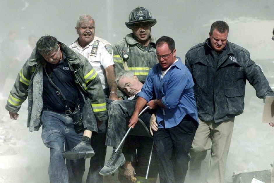 Rescue workers carry mortally injured New York City Fire Department chaplain, the Rev. Mychal Judge, from the wreckage of the World Trade Center in New York City September 11, 2001. PHOTO: Reuters 