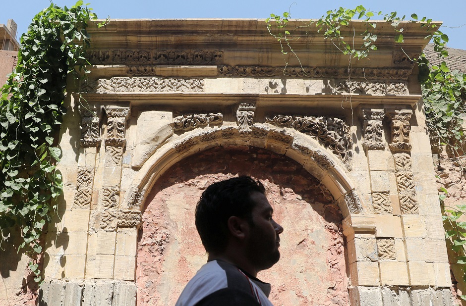  A young woman stands in front of an old wooden door by a historic house in Darb al-Ahmar neighbourhood in Cairo, Egypt August 31, 2019. PHOTO: REUTERS