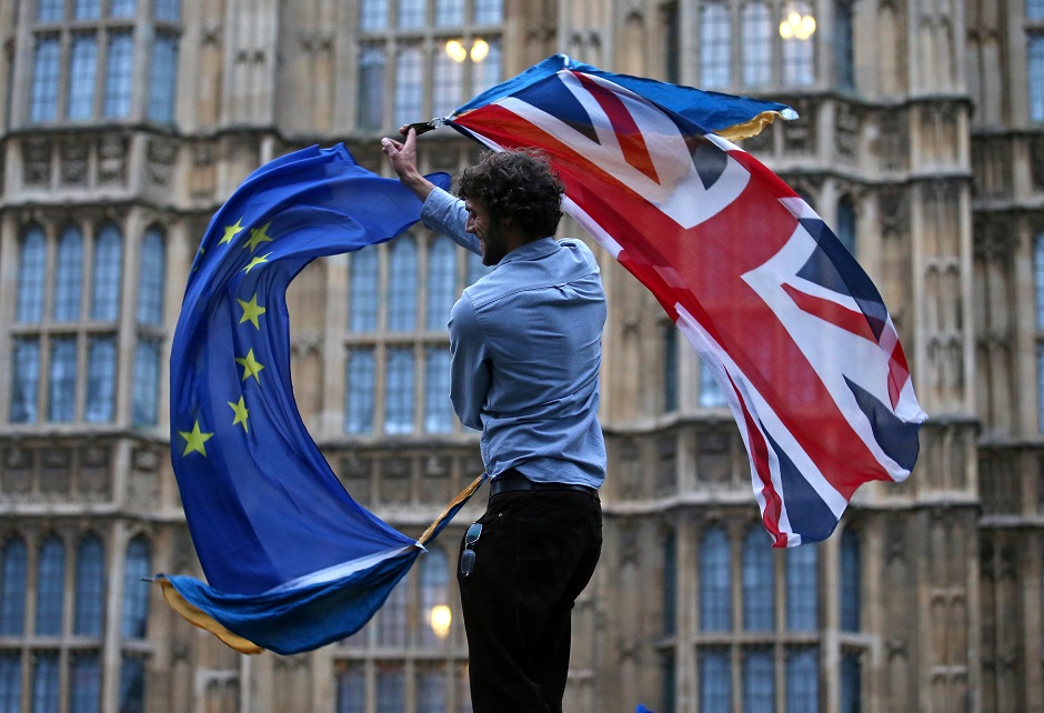 In this photo, a man waves both a Union flag and a European Union flag together on College Green outside The Houses of Parliament at an anti-Brexit protest in central London. PHOTO: AFP
