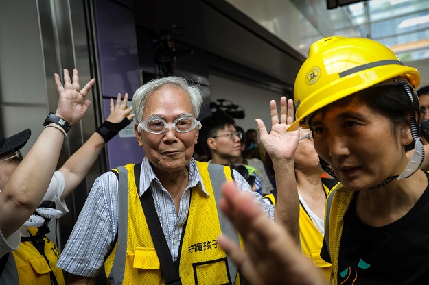 'Grandpa Wong', 85, shielding protesters from the police by stepping between them along with other 