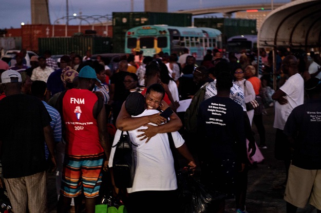 Refugees of Hurricane Dorian arrive at the Kendal GL Isaacs National Gym. PHOTO: AFP