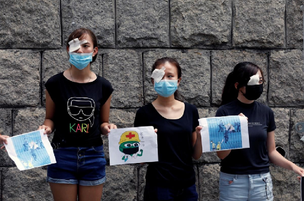 Medical students hold hands as they form a human chain during a protest against the police brutality, at the Faculty of Medicine in The University of Hong Kong, China. PHOTO: Reuters