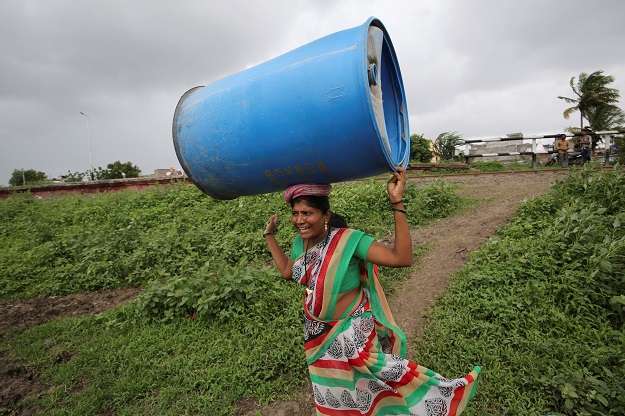 A woman carries a plastic container in Aurangabad. PHOTO: Reuters