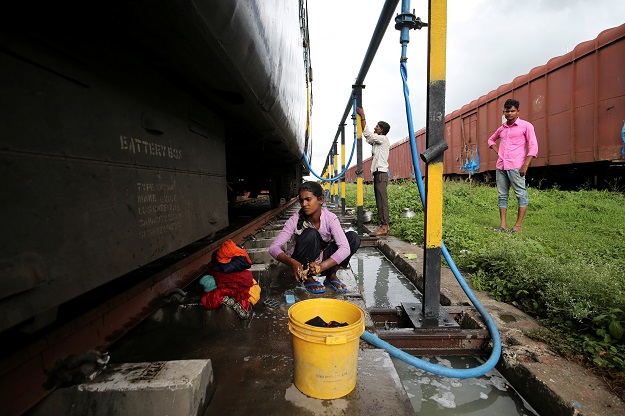 Anjali Gaikwad, 14, washes clothes at Aurangabad railway station. PHOTO: Reuters