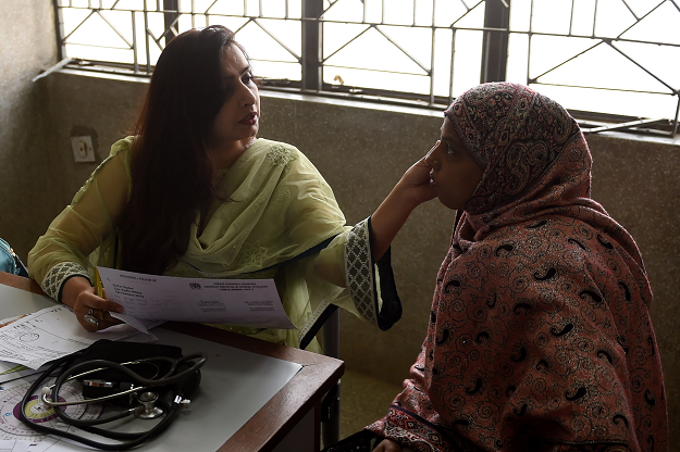 In this picture taken on January 8, 2019, a gynaecologist speaks with a patient at a government hospital in Karachi. PHOTO: AFP