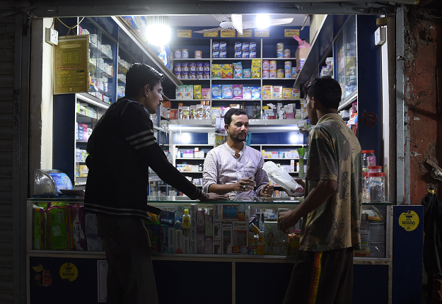 In this picture taken on January 9, 2019, a Pakistani man buys a sanitary pad from a shop in Karachi. PHOTO: AFP