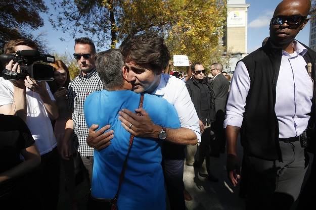 Trudeau hugs a suppourter after addressing the media regarding the pictures that surfaced. PHOTO: AFP