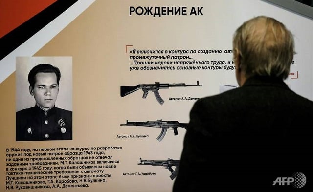 a visitor reads up on the exploits of quot kalashnikov a soldier a designer a legend quot at moscow 039 s victory museum photo afp