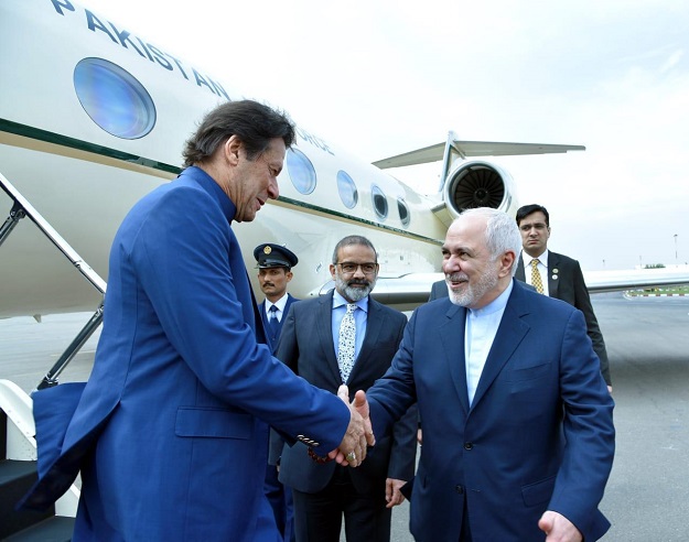 PM Imran Khan is received by Iranian FM Javad Zarif on his arrival in Tehran on October 13. PHOTO: PID