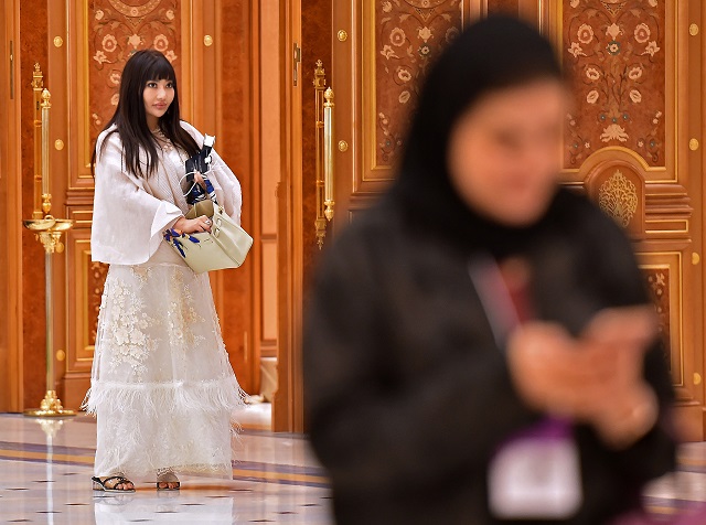 a picture taken on october 31 2019 shows a foreign woman wearing an embroidered tunic during the future investment initiative fii forum at the king abdulaziz conference centre in capital city riyadh photo afp