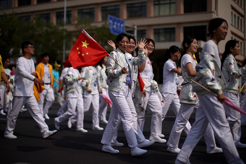  Performers wave to the camera as they leave after the parade marking the 70th founding anniversary of People's Republic of China. PHOTO : Reuters