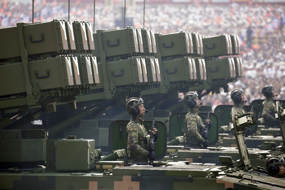  Soldiers of People's Liberation Army (PLA) stand on military vehicles travelling past Tiananmen Square during the military parade. PHOTO: Reuters 