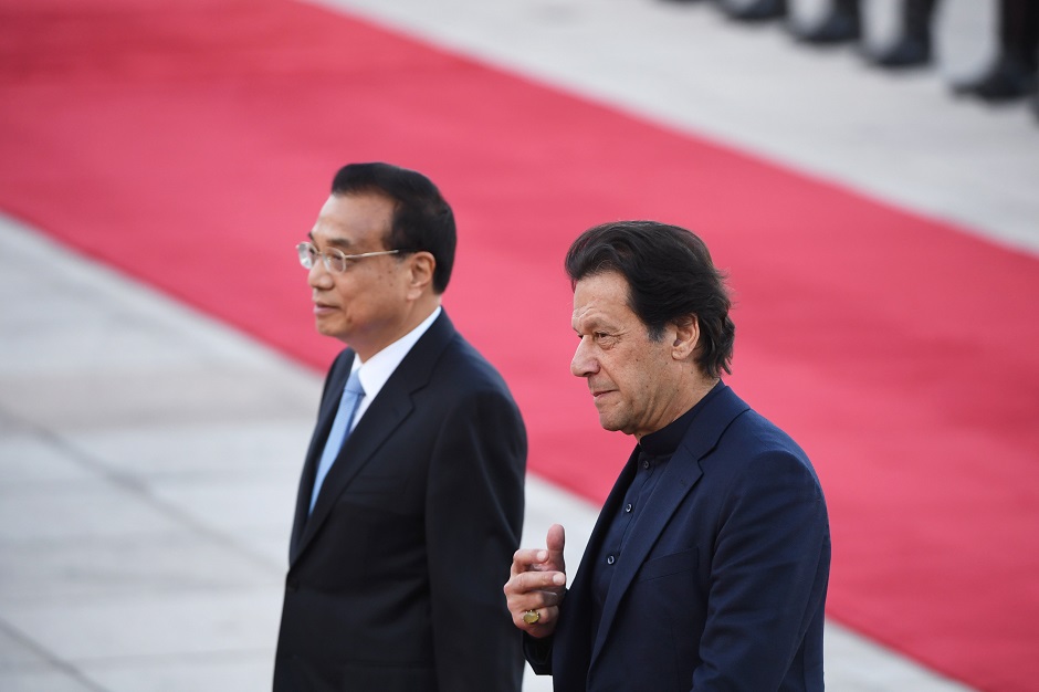 Pakistani Prime Minister Imran Khan (R) walks with Chinese Premier Li Keqiang during a welcome ceremony outside the Great Hall of the People in Beijing. PHOTO: AFP