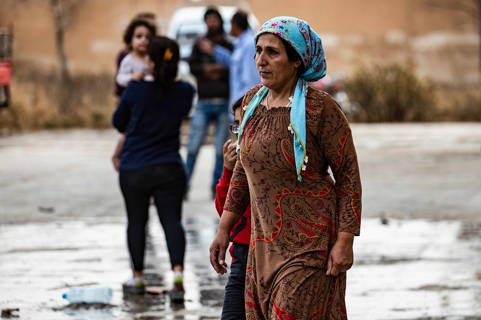 Displaced Syrian women are pictured as Arab and Kurdish civilians flee amid Turkey's military assault on Kurdish-controlled areas in northeastern Syria. PHOTO: AFP