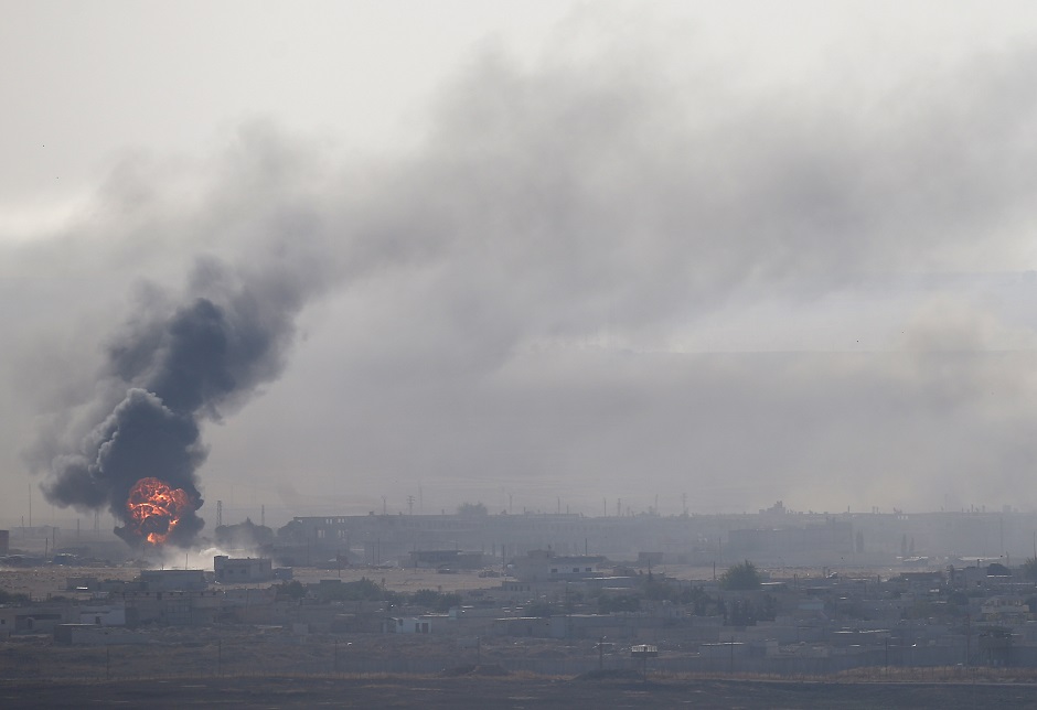  An explosion is seen over the Syrian town of Ras al-Ain as seen from the Turkish border town of Ceylanpinar. PHOTO: REUTERS