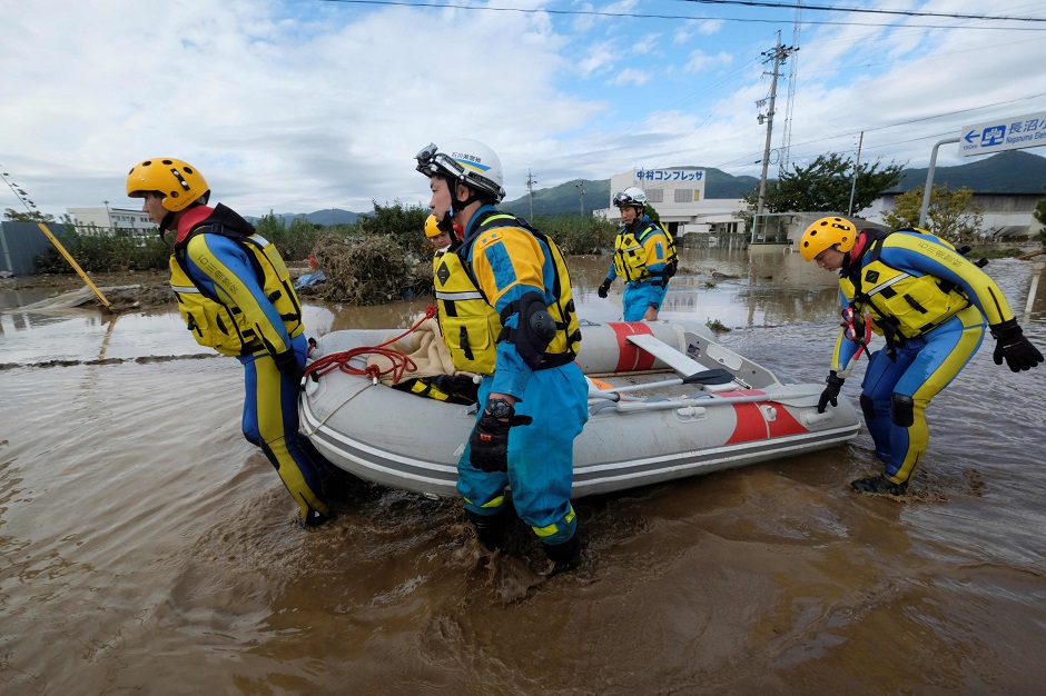 Rescue workers help residents evacuate an area. PHOTO: REUTERS