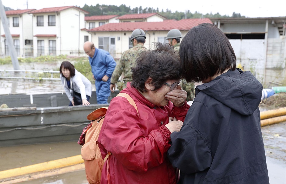  A woman cries in relief after being rescued from an area flooded by Typhoon Hagibis. PHOTO: REUTERS