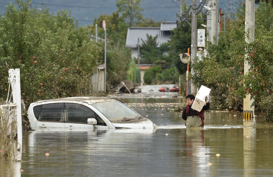 A vehicle travels down a flooded street. PHOTO: AFP