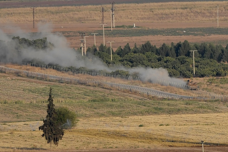 Turkish army tank driving on a field at the border town Ceylanpinar in Sanliurfa near the Syrian town of Ras al-Ain. PHOTO: AFP