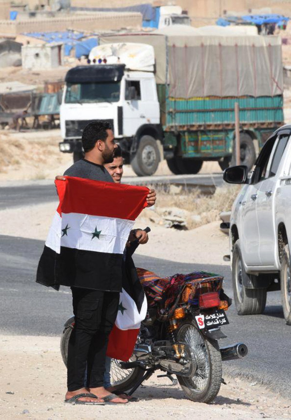 Syrian man holding a national flag . PHOTO: AFP