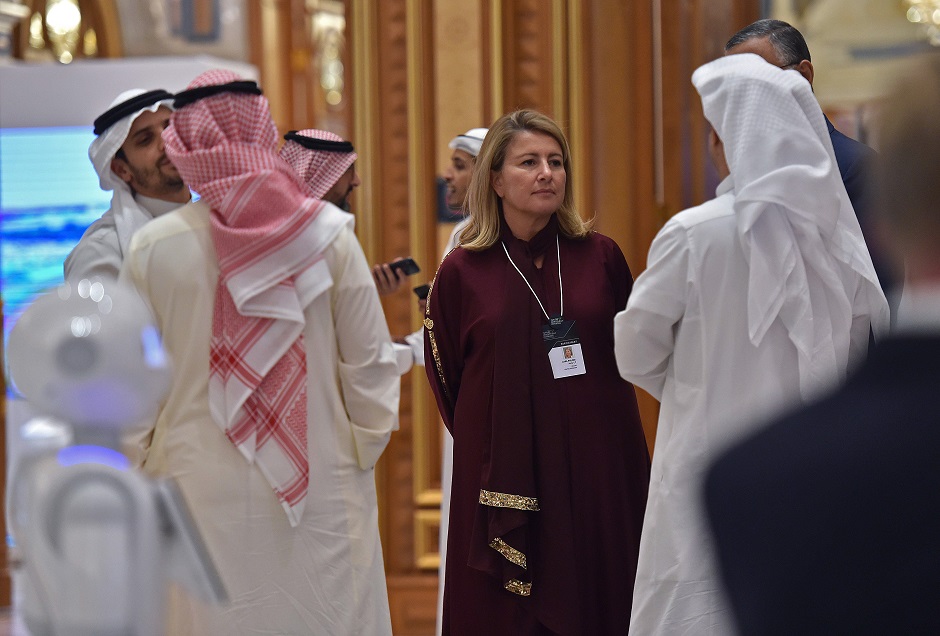 a foreign woman in an embroidered tunic chatting with other participants during the Future Investment Initiative (FII) forum at the King Abdulaziz Conference Centre in Saudi Arabia's capital Riyadh. PHOTO: AFP