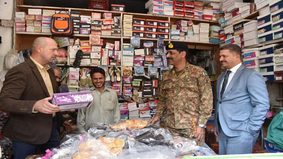 A diplomat doing shopping from a damaged shop in Jura bazaar, AJK. PHOTO: EXPRESS 