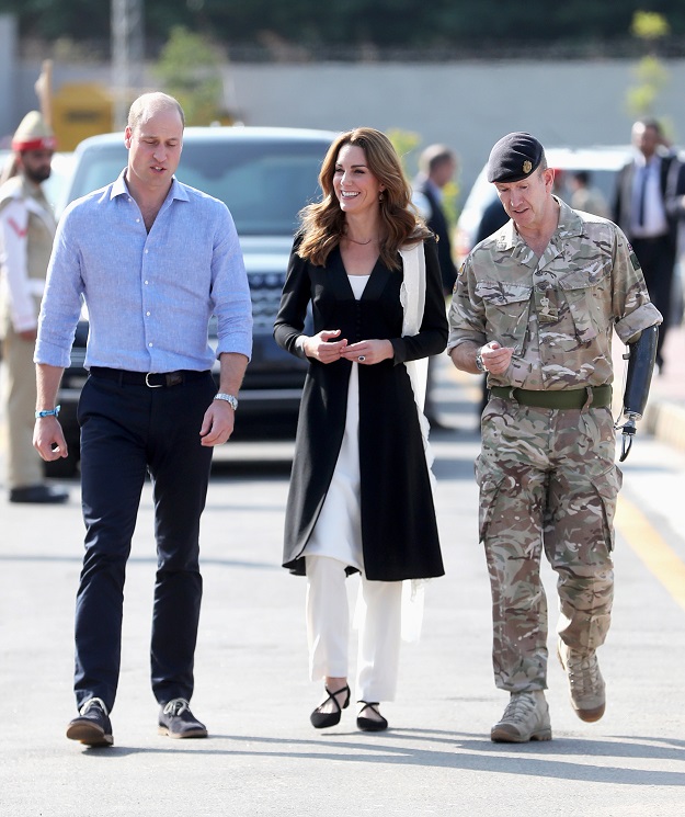 Prince William and Kate Middleton walk with British Army Lieutenant Colonel Colin Whitworth. PHOTO: Reuters