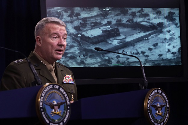 US Marine Corps Gen Kenneth McKenzie, commander of US Central Command, speaks as a picture of the operation targeting Abu Bakr al-Baghdadi is seen during a press briefing. PHOTO: AFP