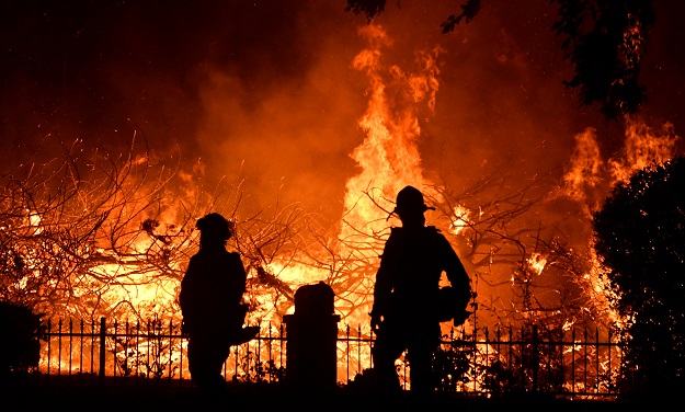 Firefighters battle a wind-driven wildfire (Photo: Reuters)