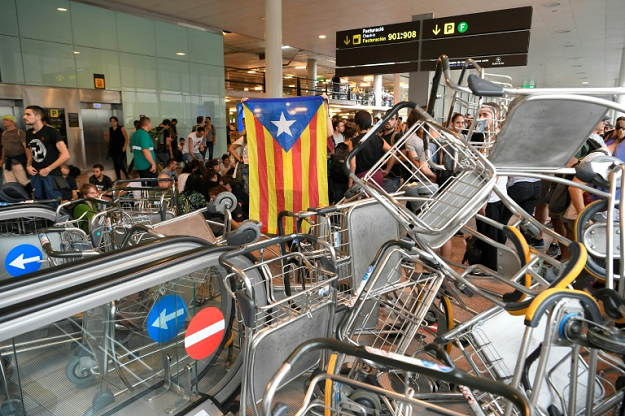 Demonstrators used luggage trolleys to block escalators at the airport. PHOTO: AFP