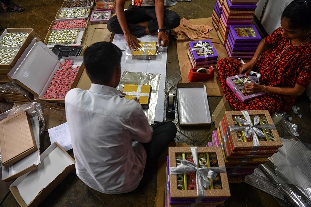 Staff pack gift boxes at a factory in Mumbai ahead of the Hindu festival Diwali. PHOTO: AFP