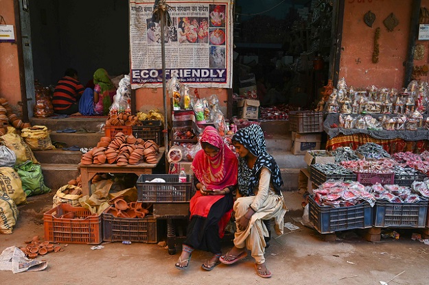 In this photograph, women sit outside their shop displaying items made of clay, at Kumhar Gram (Potter's Village) in New Delhi. PHOTO: AFP