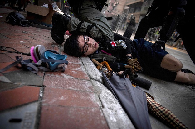 Police detain a protester on a road in the Wanchai area in Hong Kong (Photo: AFP)
