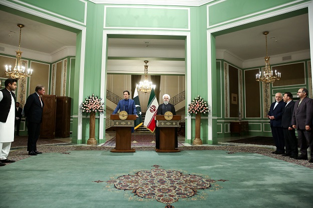 PM Imran Khan and Iranian President Hassan Rouhani address a joint press conference in Tehran. PHOTO: REUTERS