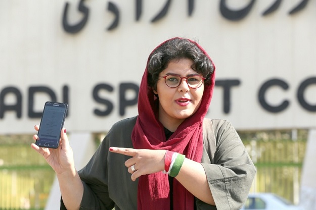 Iranian sports journalist Raha Pourbakhsh shows purchased electronic tickets for the Iran-Cambodia World Cup 2022 match in front of Azadi stadium in the capital Tehran. PHOTO: AFP