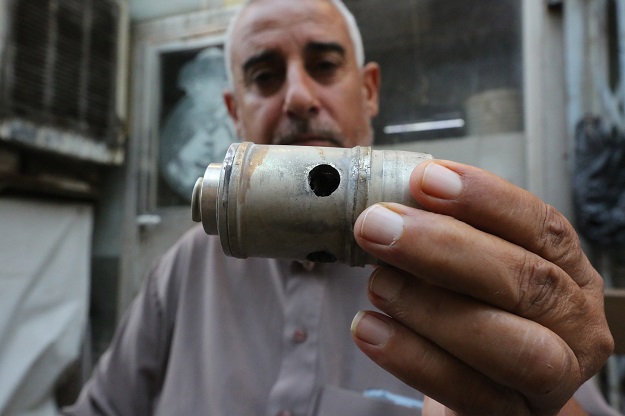 An Iraqi man shows an empty tear gas canister in the capital Baghdad's Tahrir square on October 26, 2019 (Photo: AFP)