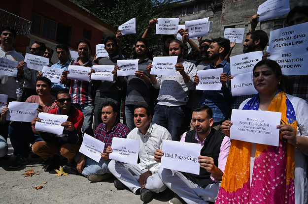 Journalists hold signs during a protest against the ongoing restrictions of the Internet and mobile phone networks at the Kashmir Press Club during a lockdown in Srinagar on October 3, 2019. PHOTO: AFP