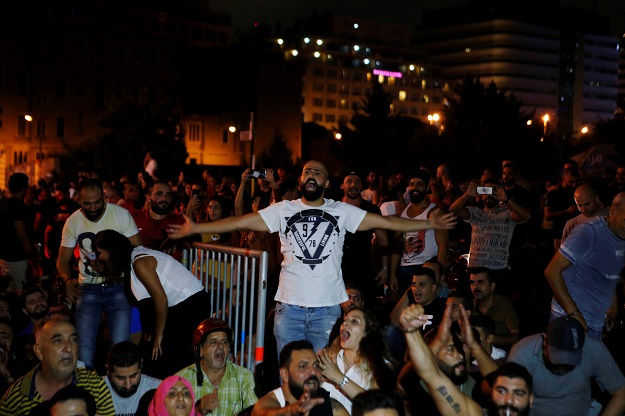People gesture and chant slogans during a protest over deteriorating economic situation in Beirut. PHOTO: Reuters