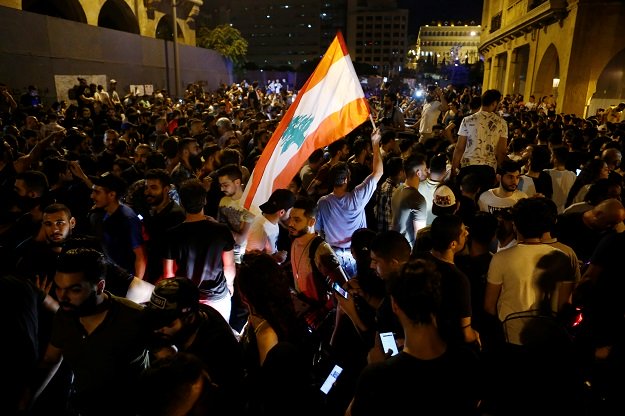 A demonstrator holds a Lebanese flag during a protest. PHOTO: Reuters