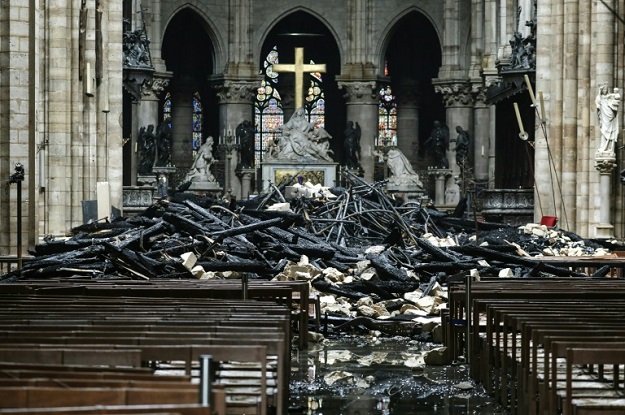 The altar surrounded by charred debris inside Notre-Dame after the fire (Photo: AFP)