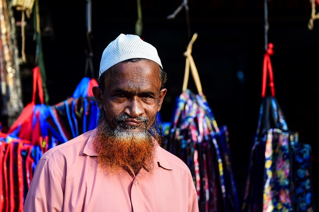 Vegetable vendor and henna enthusiast Siddikur Rahman with a henna-dyed beard and hair poses for a photo in Dhaka (Photo: AFP)