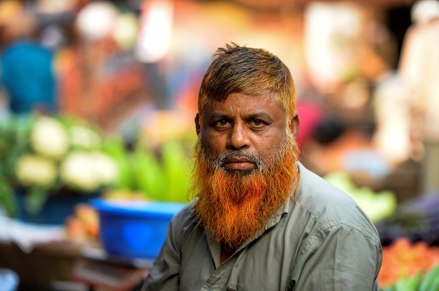 Vegetable vendor and henna enthusiast Munir Hossain with a henna-dyed beard and hair poses for a photo in Dhaka (Photo: AFP)