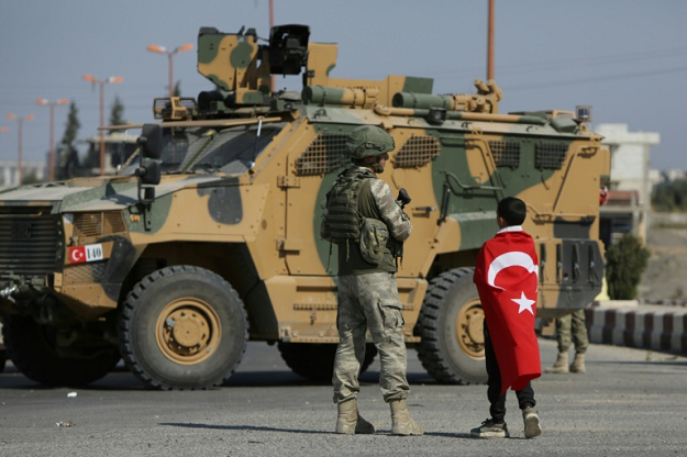 Turkish soldiers patrol the Syrian border town of Tal Abyad, part of an Arab-majority strip along the frontier where Ankara will retain full control under the deal reached with Moscow. PHOTO: AFP