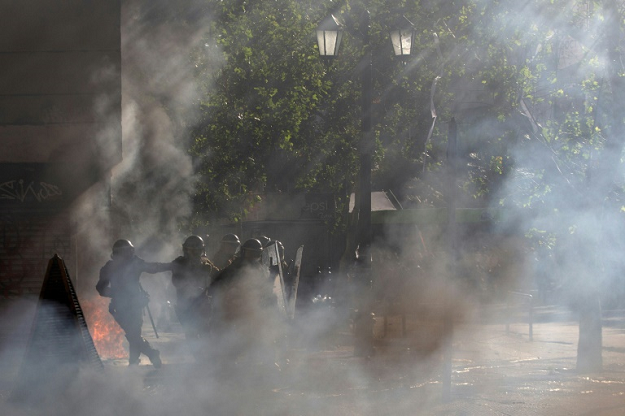 Riot police clash with demonstrators in Santiago on October 24, 2019. PHOTO: AFP