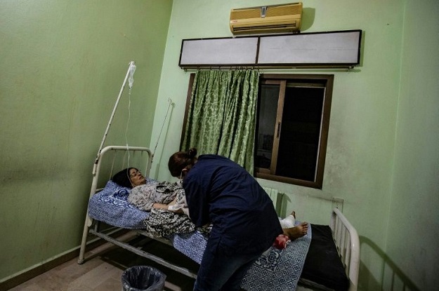 A wounded woman receives treatment at a hospital in Qamishli. PHOTO: AFP