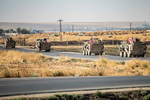 US military vehicles are seen patrolling along a road near the town of Tal Baydar in the countryside of Syria's northeastern Hasakeh province on October 12, 2019. PHOTO: AFP