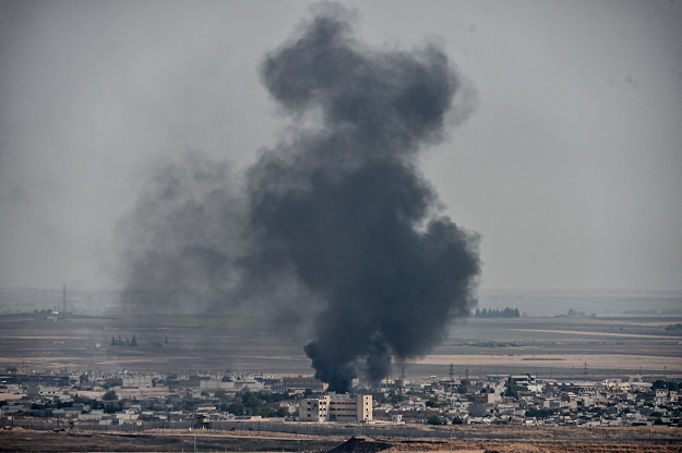Smoke rises from the Syrian town of Ras al-Ain, in a picture taken from the Turkish side of the border in Ceylanpinar on October 11, 2019, on the third day of Turkey's military operation against Kurdish forces. PHOTO: AFP