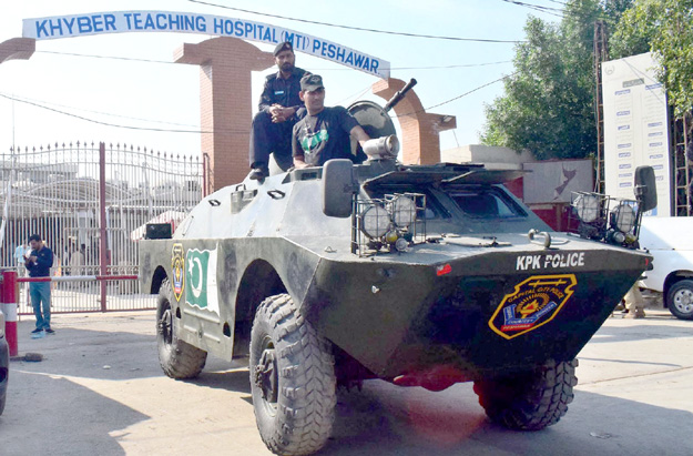 An armoured vehicle stands in front of the Khyber Teaching Hospital in Peshawar. PHOTOS: INP